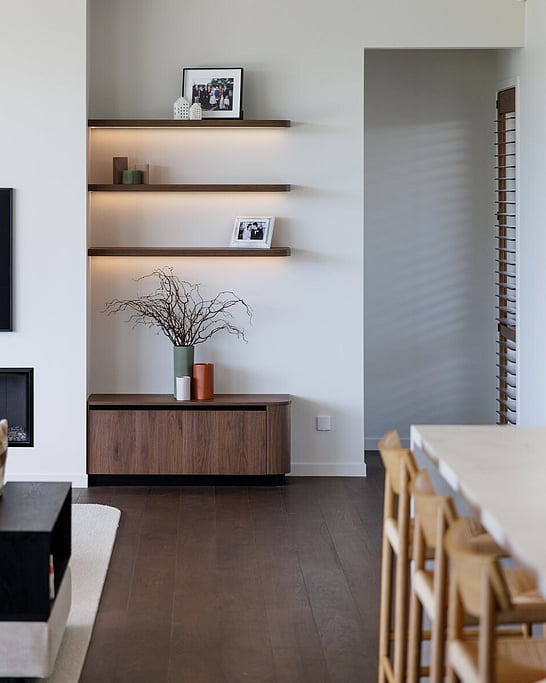 Natural wood floor and black fireplace in a lounge setting.