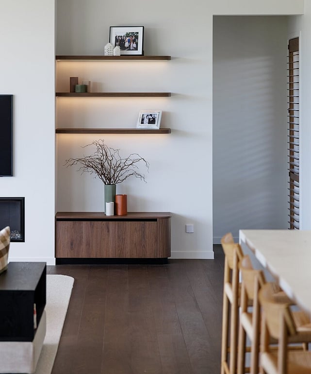 Natural wood floor and black fireplace in a lounge setting.