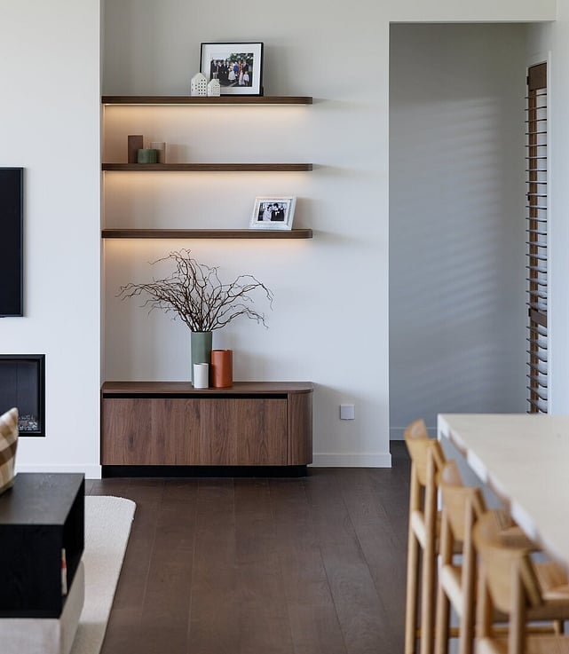 Natural wood floor and black fireplace in a lounge setting.