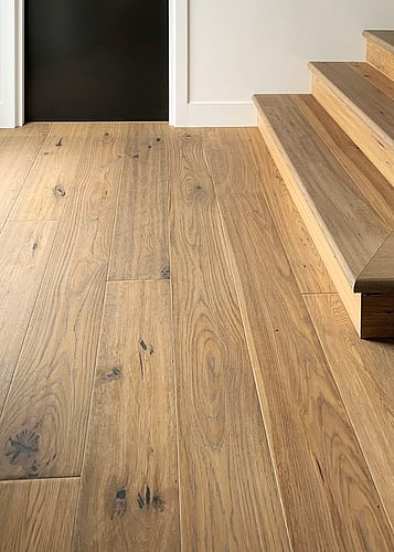 Natural oak flooring in a hallways and wooden stairs.