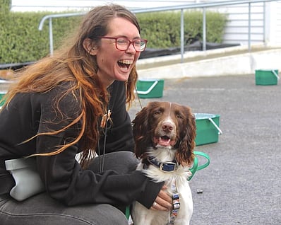 A happy lady training her happy dog