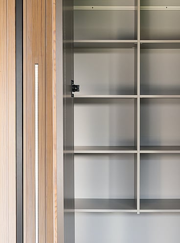 Built-in coloured shelving with solid wood doors