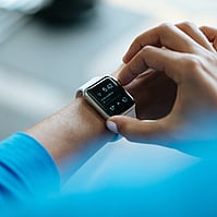 Image of somone looking at a watch representing Gallie Miles being on time for appointments