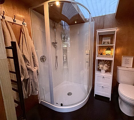 Bathroom: “Private bathroom with shower, toilet and luxury amenities at Forest Hillside Glamping Retreat.”
