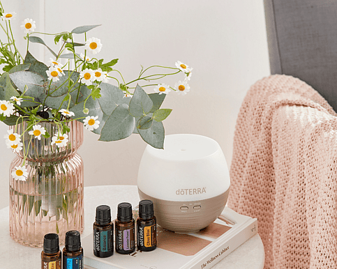 doterra diffuser doterra essential oils a vase and a book on a table