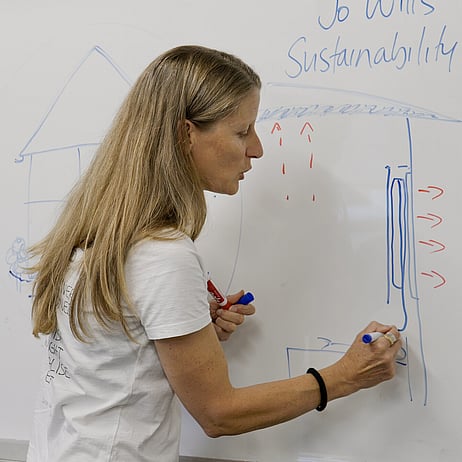 Woman writing on whiteboard