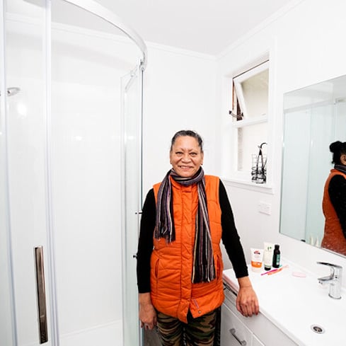 Person standing smiling in bathroom