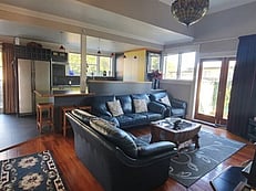Living room area with kitchen in background