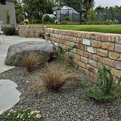 brick wall retaining wall with crazy paving at a property in Rotorua