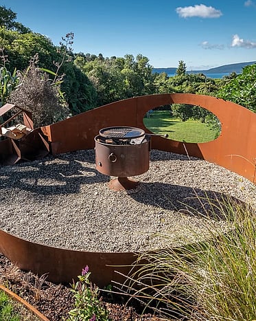 Custom landscape design with native planting and stone features and rolled lawn