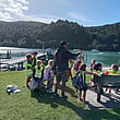 Young people playing outside by the water