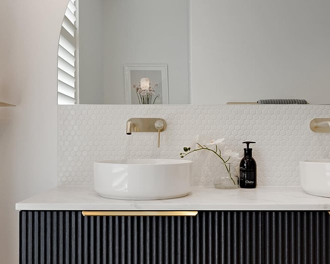 Curved mirror above a vanity