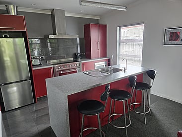 The red kitchen and island bench at 14A Cologne Street
