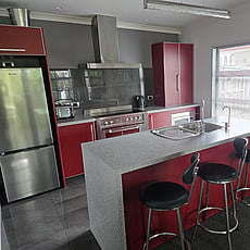 The red kitchen and island bench at 14A Cologne Street