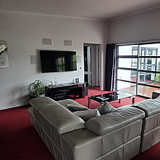 View of large TV from behind the sofa at 14 Cologne St