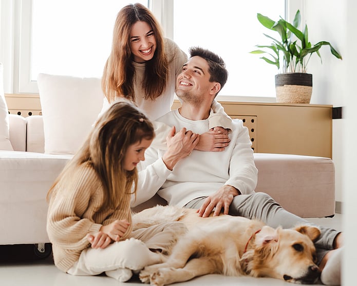 Photo of young family, mum, dad, daughter and dog