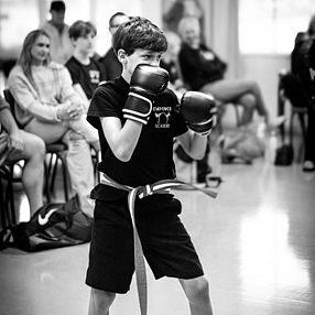 White belt kickboxer doing a turning kick