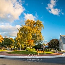 St Andrew's Anglican Church and autumn trees on a Cambridge street roundabout, New Zealand