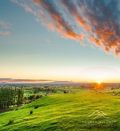 Golden sunset light over rolling green hills near Hidden Lake, Cambridge