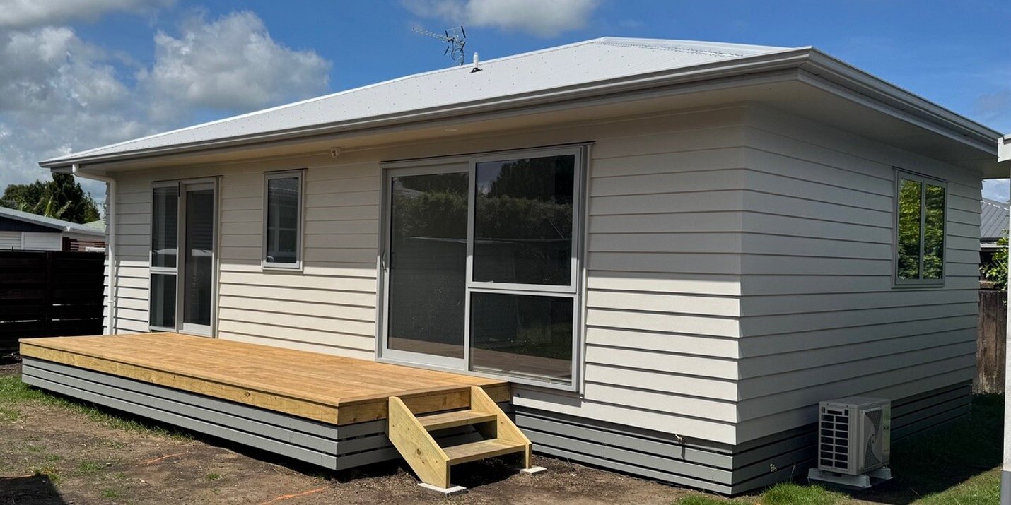 Ardent Building Developments. Hamilton, Waikato. NZ. Image of small beige building with decking.
