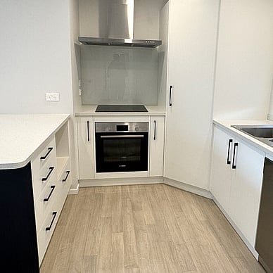 Image of fresh new neutral toned kitchen with black handles & accents. Vercoe Road small building. Built by Ardent Building Developments, Hamilton. Waikato, New Zealand.