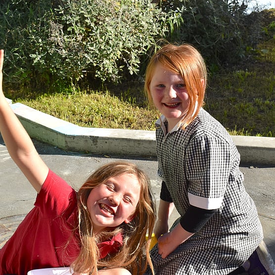 after school programme, two girls playing outside