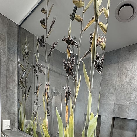 Image of stone edged shower wall with flowering flax splashback in Te Wharepu Road new home build. Built by Ardent Building Developments, Hamilton. Waikato, New Zealand.