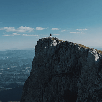 Person on top of a mountain for Practical Christianity bible courses