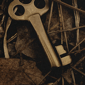 A bronze key hidden in some brown leaves for Children's  Studies Bible Course