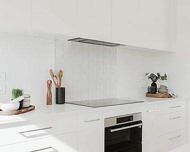 Image of light filled white kitchen and modern black appliances in Collinson Street, Pirongia new home, by Waikato residential builders Whitechurch Construction Limited.