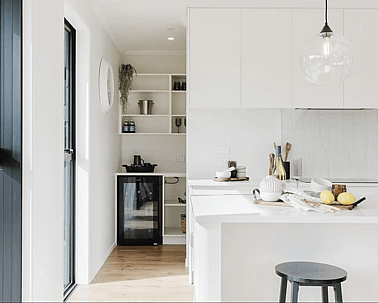 Image of light filled white kitchen and modern black appliances in Collinson Street, Pirongia new home, by Waikato residential builders Whitechurch Construction Limited.