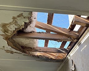 Image of damaged roof with hole in it