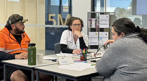Three adults in conversation