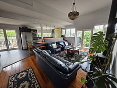 Living room area with kitchen in background