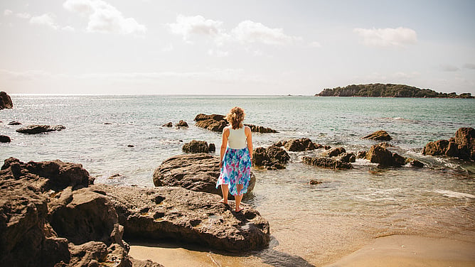 Amy Brailey, strategic brand designer for the wedding industry, looking out at sea
