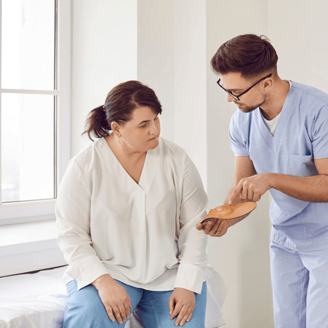 Podiatrist explaining foot condition to a patient during consultation at Foot Foundation