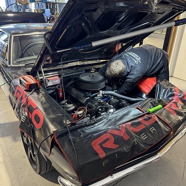 Conrad with his two children and also working on a truck