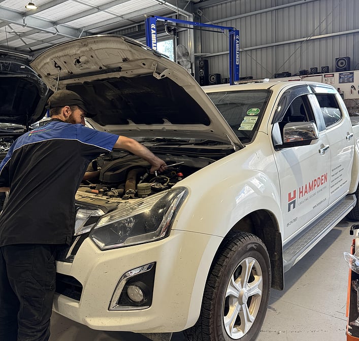 Man working on electrical with bonnet of the car up