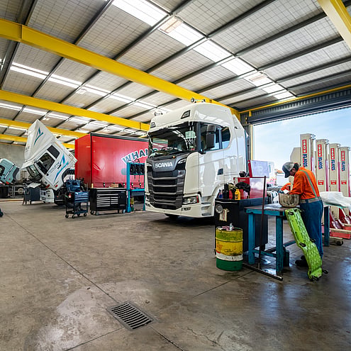 Workshop of heavy truck and trailers, multiple trucks in the workshop