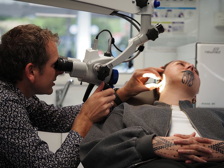 Dr David Waterhouse Examining a patient with an ENT microscope