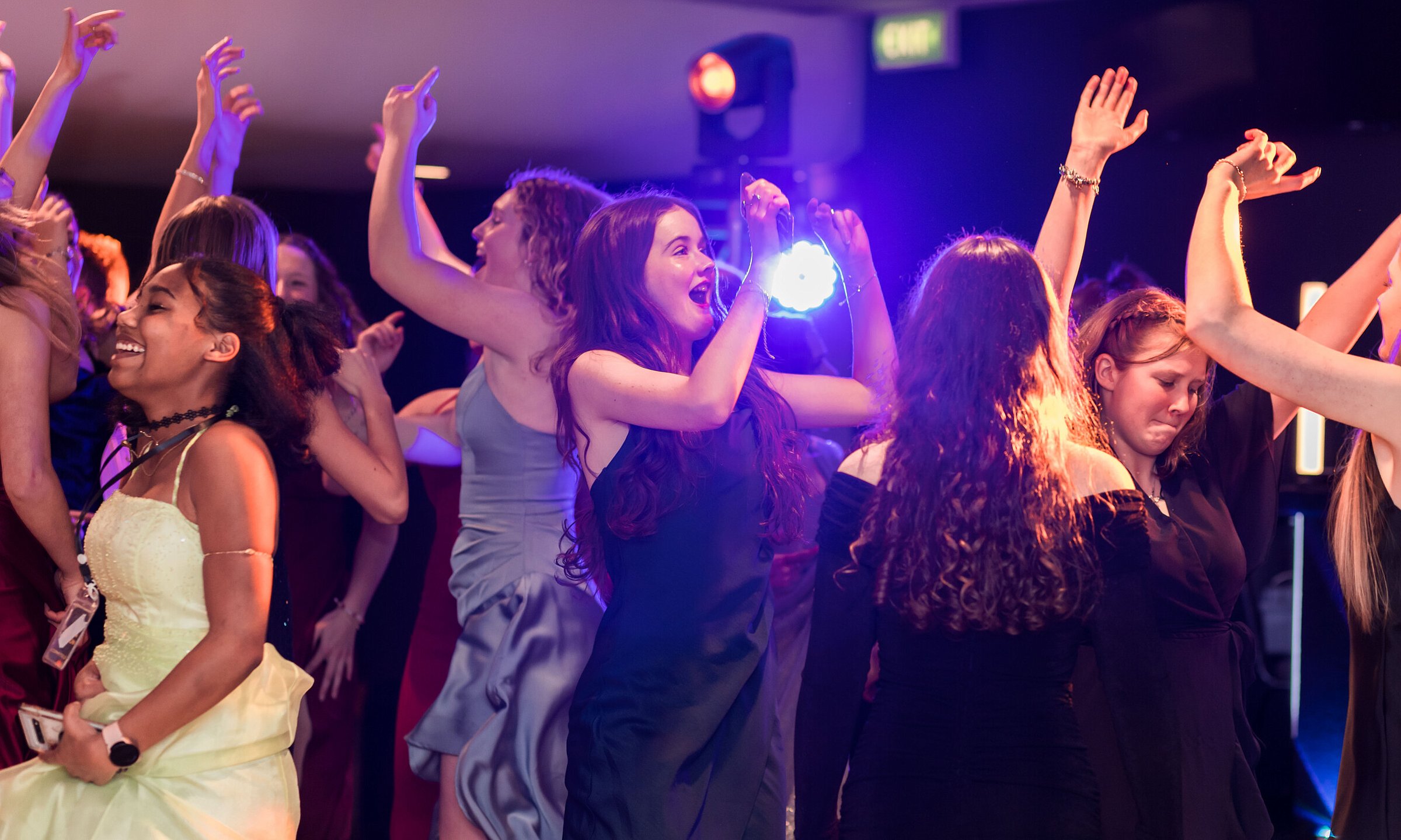 Students on a packed dance floor at a Canterbury school ball