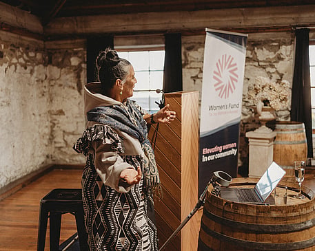 Anah Aikman hosting an impactful event as an MC, weaving storytelling and cultural traditions into an empowering experience for attendees.