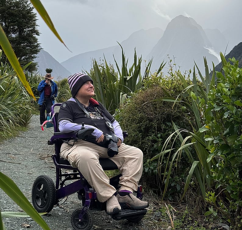 Man in a wheelchair enjoying a scenic path along one of New Zealand's stunning Sounds