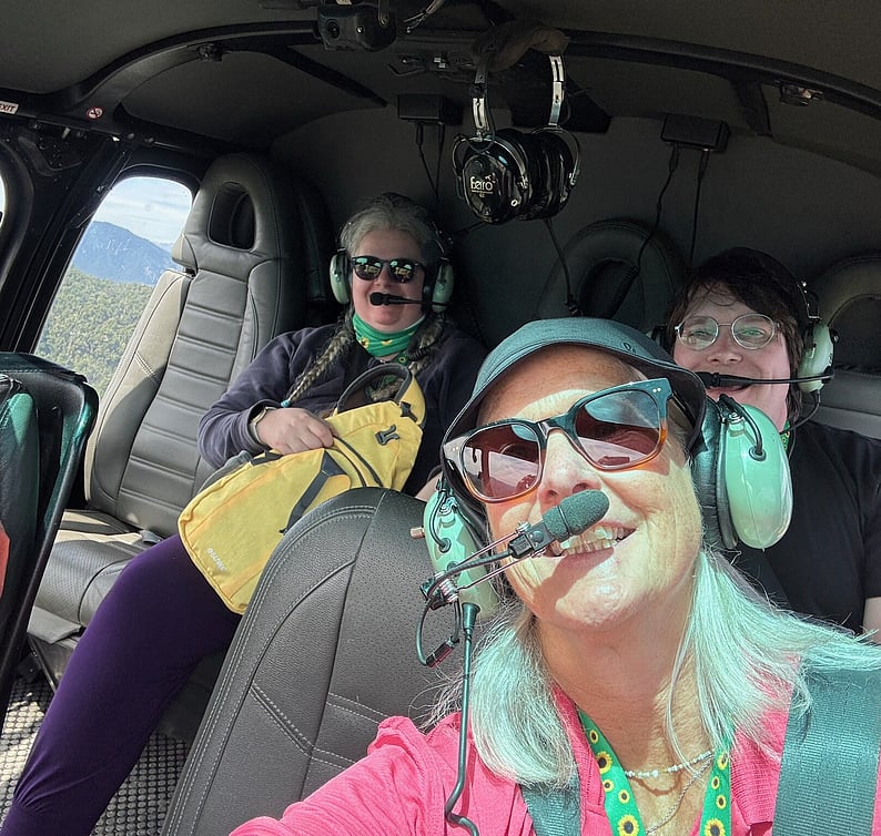 Occupational therapist sharing a scenic helicopter ride with clients over New Zealand