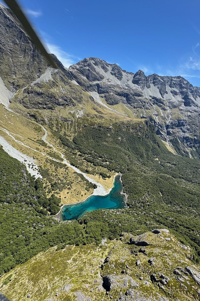 Panoramic view of a glacial valley and alpine lake along the Routeburn Track in New Zealand&rsquo;s Southern Alps.