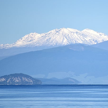 Mount Tauhara and a small island viewed across the calm waters of Lake Taupo