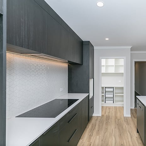 Image of modern tiled kitchen back splash. Tiling service by Cosmic Tiling. Waikato.