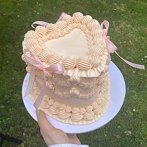 Beautiful photo of gluten free chocolate gateau decorated with flowers and tiny gold balls.