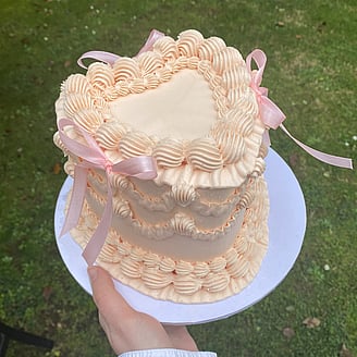 Beautiful photo of gluten free chocolate gateau decorated with flowers and tiny gold balls.