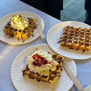 Photo of mini donuts in various colours with colourful sprinkles